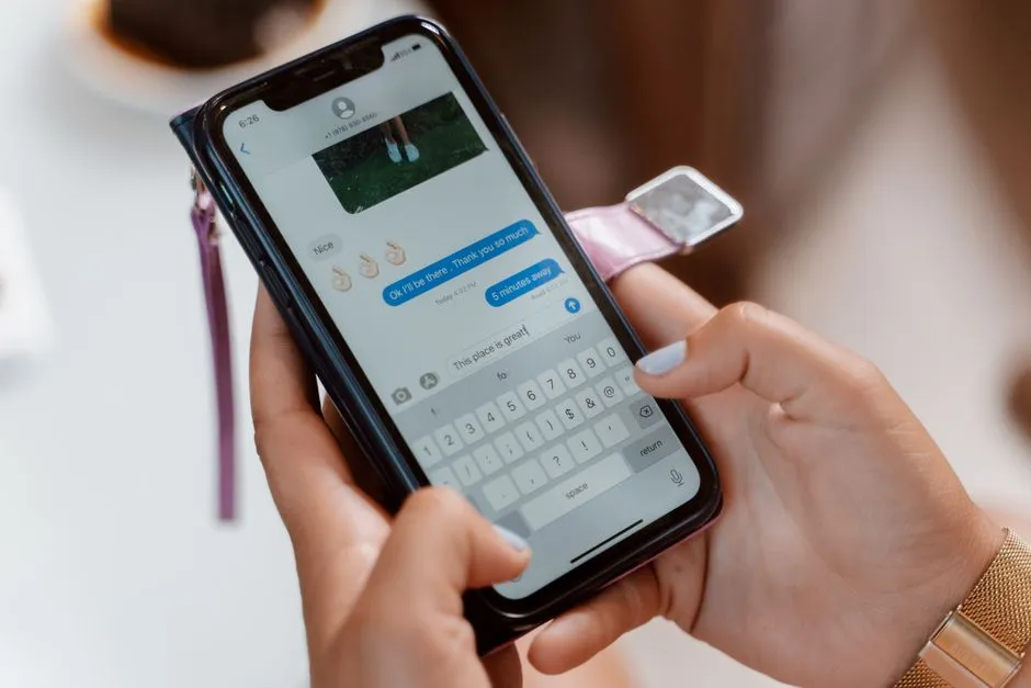 Close-up of a person sending a text message on a smartphone, illustrative photo
